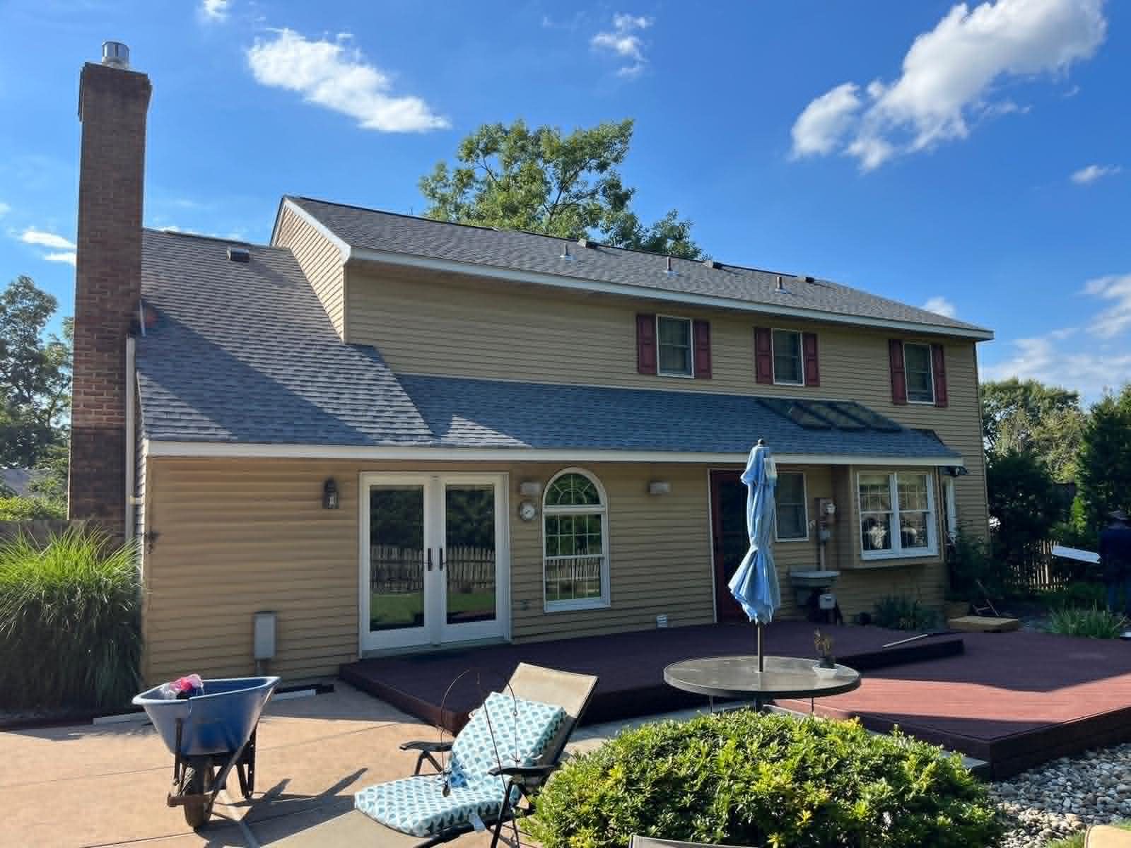 Residential chimney rebuild viewed from the backyard — Legacy Peak Roofing & Construction, New Jersey