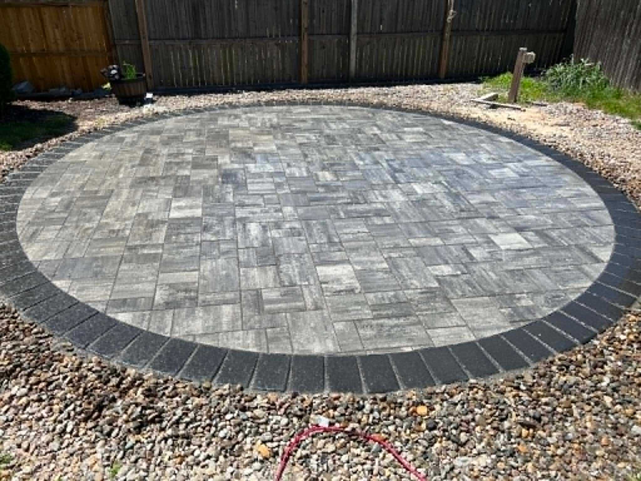 Paver patio power washing and re-sanding by Legacy Peak Roofing & Construction
