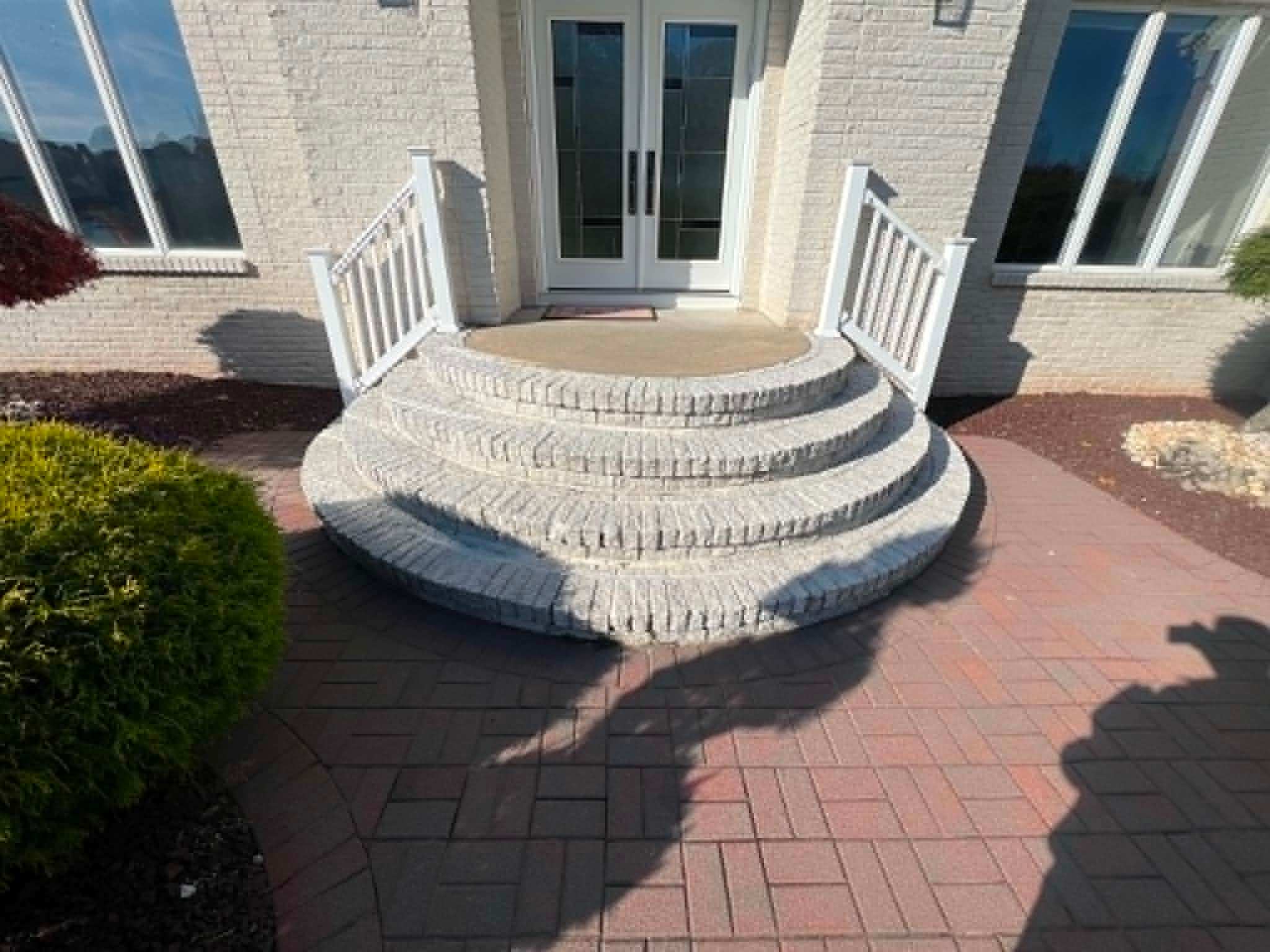Curved radius paver steps leading to a French door entry, New Jersey