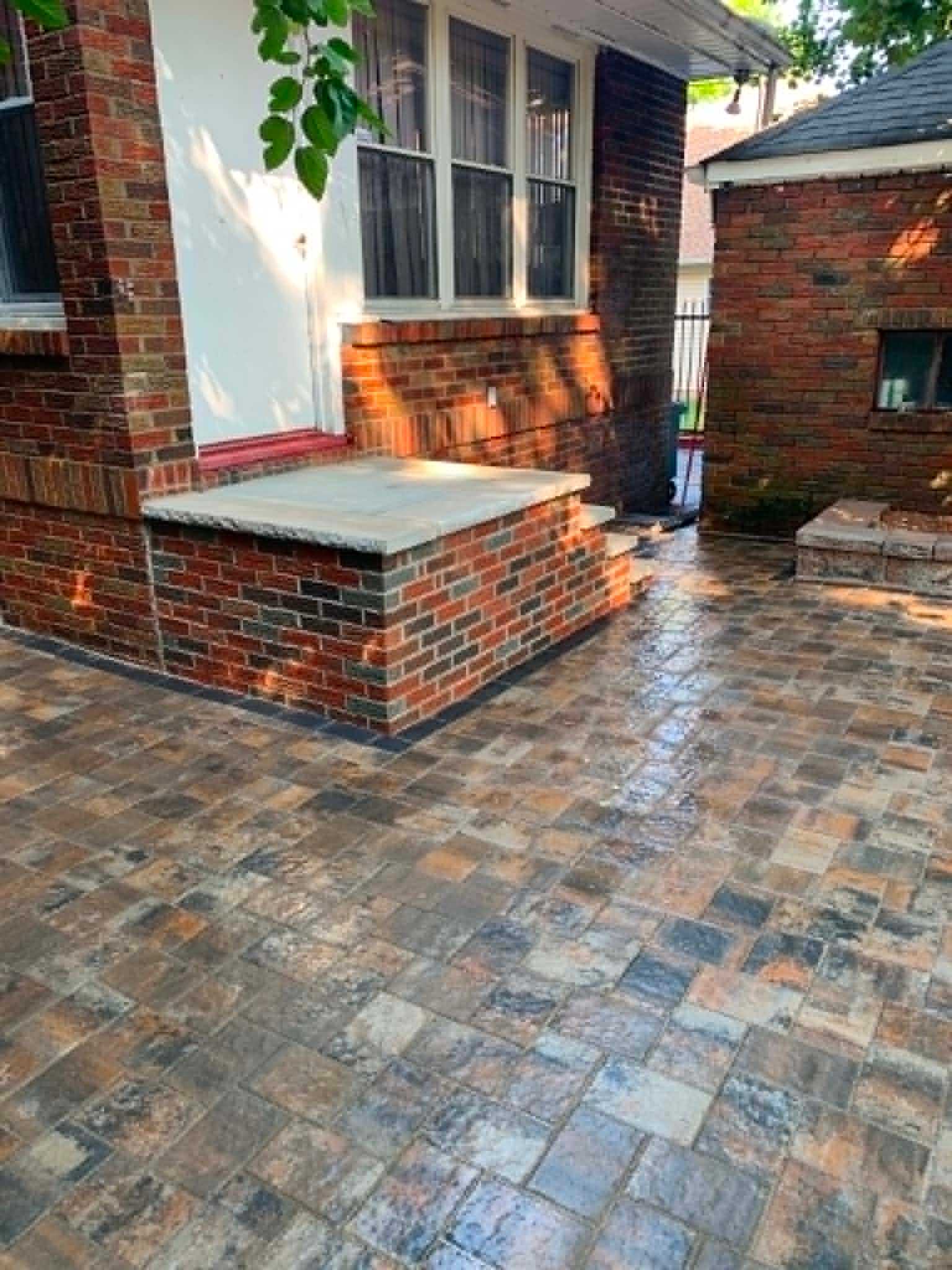 Paver patio with brick seating wall built by Legacy Peak Roofing & Construction, New Jersey